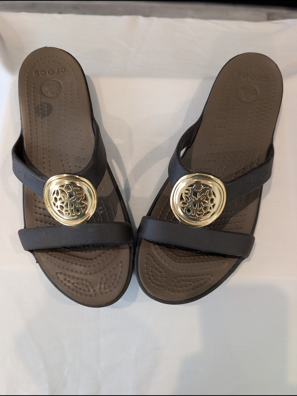 Crocs Women’s Black Slide Sandals with Gold Medallion